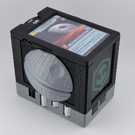 A 3D-printed Star Wars RPG accessory featuring a gray Death Star dome on a black textured cube base, with a Star Wars card embedded on top, photographed on a light gray studio background.
